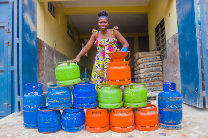 Une bénéficiaire de MIVO au Togo présente les réchauds de cuisson à gaz qu'elle revend.