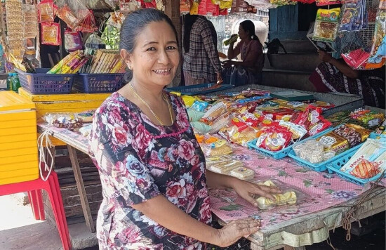 Une bénéficiaire de SOO au Myanmar pose devant son épicerie.